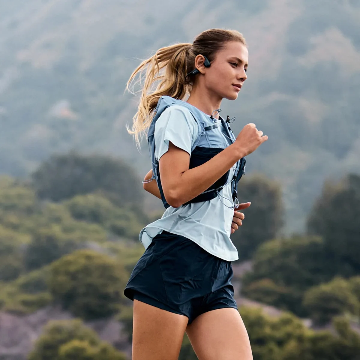 A runner wearing Shokz OpenRun Pro 2 headphones