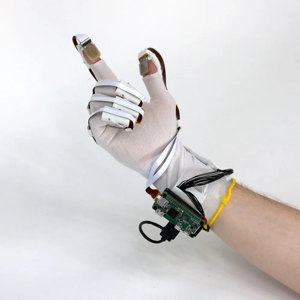 Fluid Reality haptic glove (2023) - Physical Fluid Reality glove prototype photographed on a hand. Credit: Fluid Reality & CMU.