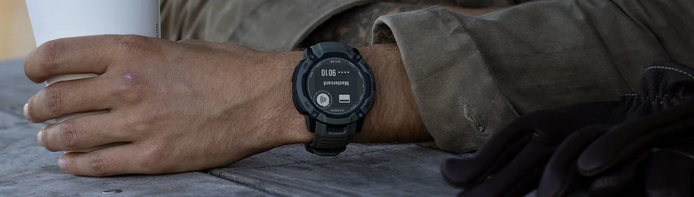Garmin Instinct 2X Solar - Original Garmin photograph showing Garmin Instinct 2X Solar. Promotional screens may be composited; physical hardware is shown.