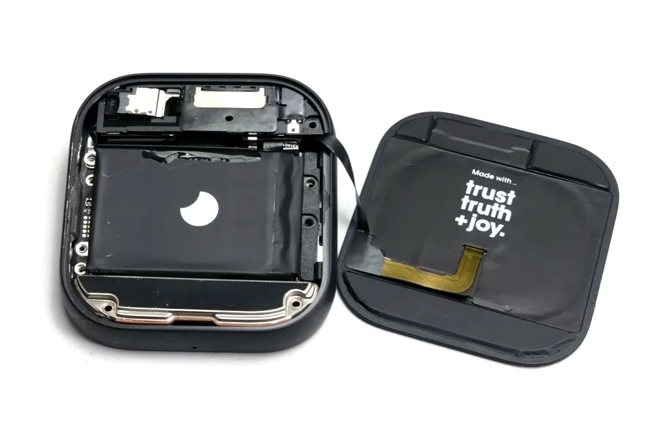 Humane Ai Pin - Humane Ai Pin opened during the original iFixit teardown; rear cover removed. Credit: iFixit / Shahram Mokhtari and Chayton Ritter. Not a retail configuration or SmartWearGuide hands-on test. Photo/source credit: iFixit.